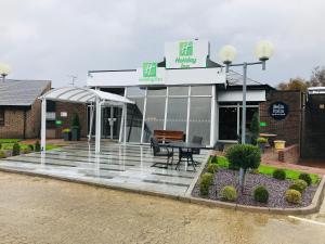 a restaurant with a table in front of a building at Holiday Inn Dover by IHG in Dover