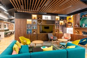 a living room with a blue couch and chairs at Holiday Inn Dover by IHG in Dover
