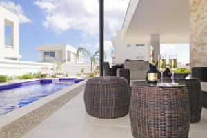 a patio with a pool and a table with wine glasses at Villa Luna in Protaras