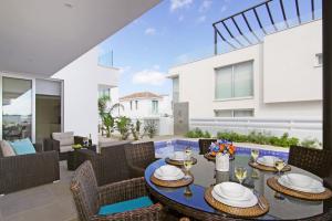 a dining room with a table and chairs in a house at Villa Luna in Protaras