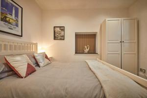 a bedroom with a large bed and a window at Host & Stay - The View Old Coastguard Cottage in Tynemouth +12 photos