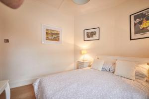 a bedroom with a bed and two pictures on the wall at Host & Stay - The View Old Coastguard Cottage in Tynemouth