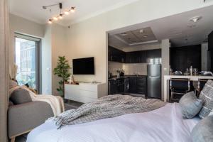 a living room with a bed and a kitchen at The Smart Concierge - Bay Central in Dubai