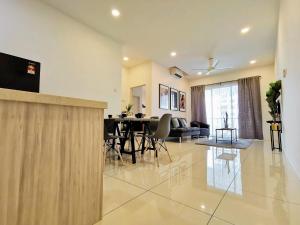 a dining room table and chairs in a room at Skypod Residence Puchong in Puchong