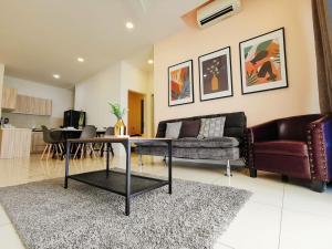 a living room with a couch and a table at Skypod Residence Puchong in Puchong