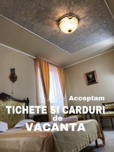 a bedroom with a bed and a ceiling at Pensiunea Cardinal in Sibiu