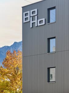 a building with a sign on the side of it at BoHo by Maier - kontaktloser Check-In in Buchs