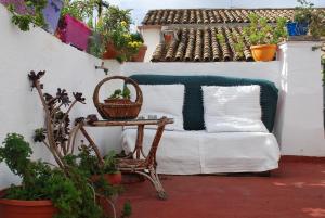 a patio with a couch and a table with a basket at Backpacker Al-Katre in Córdoba