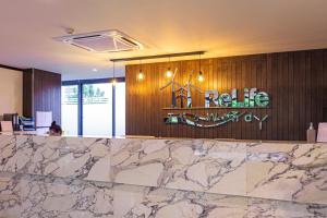 a lobby with a marble counter and a sign on the wall at Cozy design studio near Nai Harn beach in Nai Harn Beach +46 photos