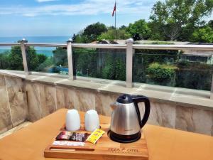 a tea kettle on a wooden table on a balcony at Feza Otel in Trabzon