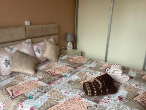 a bed with a blanket and pillows on it at Nikol Deluxe in Velingrad