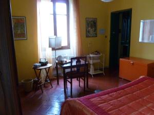 a bedroom with a table and a room with a bed at B&B Casa Manuelli in Alessandria