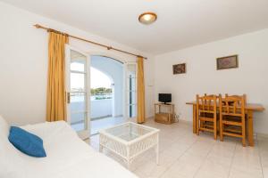 a living room with a couch and a table at Maluz in Arenal d'en Castell