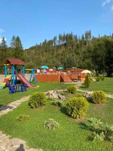 a park with a bunch of kids playing in it at Кукулька міні-готель in Slavske