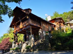 a large wooden house with a balcony on the front at Apartments DM in Mokra Gora