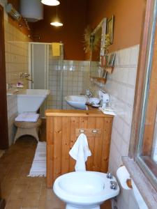 a bathroom with a sink and a toilet and a sink at B&B Casa Manuelli in Alessandria