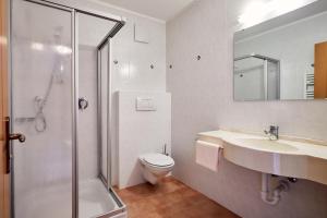a bathroom with a shower and a toilet and a sink at Ferienpension Zummüllerhof in Natz-Schabs