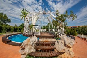 a ferris wheel and a pool with a roller coaster at Hotel Legjenda in Shkodër