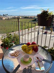 a glass table with a plate of fruit on it at B&B Come a Casa in Citta' Sant'Angelo
