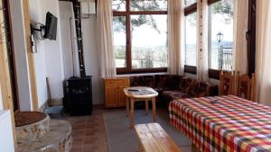 a living room with a couch and a bed at Вили Green in Tsigov Chark