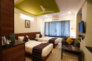 Ein Bett oder Betten in einem Zimmer der Unterkunft Silicon Inn Hotel Bangalore Airport