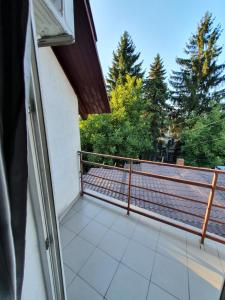 a balcony of a house with trees in the background at Bella Donna Hotel in Chişinău