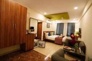 a hotel room with a bed and a living room at Silicon Inn Hotel Bangalore Airport in Devanahalli-Bangalore