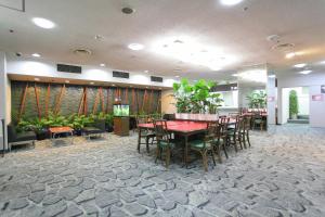 a dining room with tables and chairs in a lobby at Hotel Marutani in Tokyo