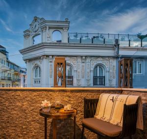 a chair and table in front of a building at Hotel Amira Istanbul in Istanbul