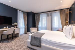 a hotel room with two beds and a table at Hotel Amira Istanbul in Istanbul