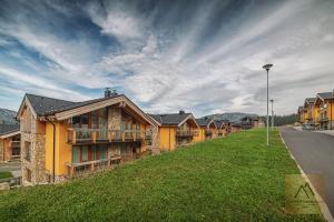 a row of houses on the side of a street at Apartment Claudie de Luxe in Demanovska Dolina