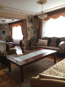 a living room with couches and a coffee table at Kwatery prywatne Jaśmin in Gniezno