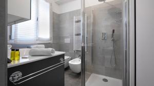 a bathroom with a shower and a toilet and a sink at Maisonette Modena Park in Modena