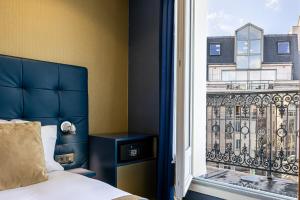Postel nebo postele na pokoji v ubytování Trianon Gare de Lyon