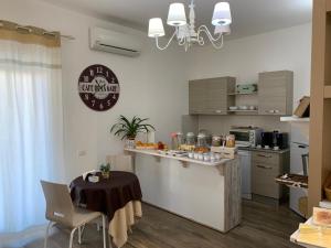 a kitchen with a counter and a table in a room at Etesia in Olbia
