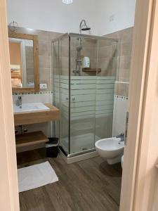 a bathroom with a shower and a sink and a toilet at Etesia in Olbia +40 photos