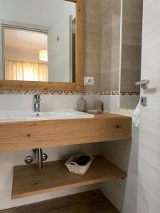 a bathroom with a sink and a mirror at Etesia in Olbia