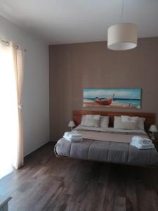 a bedroom with a bed and a lamp at Etesia in Olbia