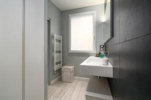 a bathroom with a white sink and a window at Dépendance Machiavelli - Apartment and Wine in Florence