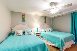 a bedroom with two beds and a ceiling fan at Sea Colony Annapolis House in Bethany Beach