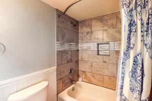 a bathroom with a tub and a toilet and a shower at Sea Colony Annapolis House in Bethany Beach +29 photos