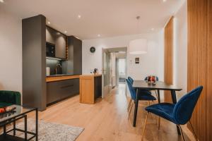 a kitchen and living room with a table and chairs at Zeus Design Apartments Prater in Vienna