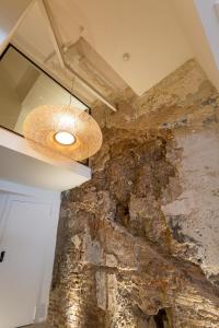 a room with a stone wall and a ceiling at Hotel Avenida in Zaragoza