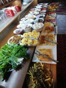 a long table with many different plates of food at Antique Terrace Cave Suites in Göreme