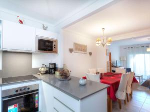 a kitchen and dining room with a table with a red table cloth at Holiday Home Isis by Interhome in L'Escala +14 photos