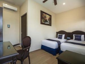 Postel nebo postele na pokoji v ubytování Woo Rooms Hotel