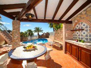 a patio with a table and a swimming pool at Holiday Home Roberto by Interhome in Pedramala