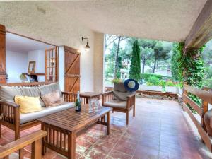 a living room with a couch and a table at Holiday Home Hermine by Interhome in Sant Martí d’Empúries