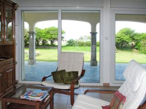 a living room with a chair and a table and a window at Holiday Home La Jolie Vague by Interhome in Beaubigny +16 photos