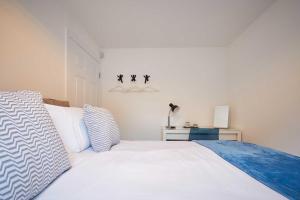 a bedroom with a white bed and a night stand at Host & Stay - Potters Bank in Durham